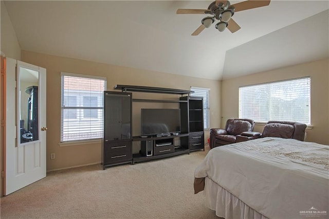 bedroom featuring ceiling fan, light colored carpet, and vaulted ceiling