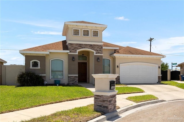1408 May Dr, Edinburg, TX 78539 - mediterranean / spanish house with stucco siding, stone siding, a front lawn, an attached garage, and concrete driveway