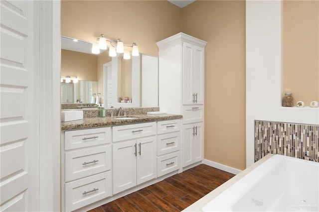 1408 May Dr, Edinburg, TX 78539 - bathroom with baseboards, a soaking tub, wood finished floors, and vanity