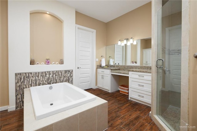 1408 May Dr, Edinburg, TX 78539 - full bathroom with a stall shower, a garden tub, vanity, and wood finished floors