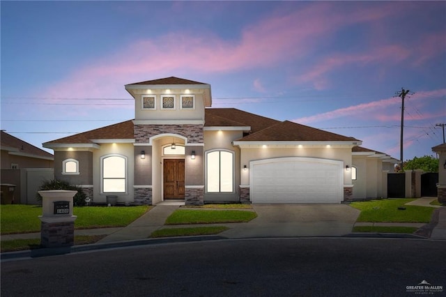 1408 May Dr, Edinburg, TX 78539 - mediterranean / spanish house featuring a garage, driveway, stone siding, and fence