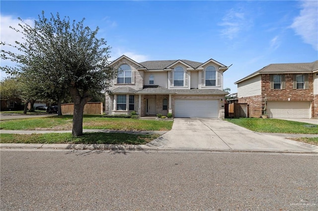 traditional home featuring a garage, driveway, and fence