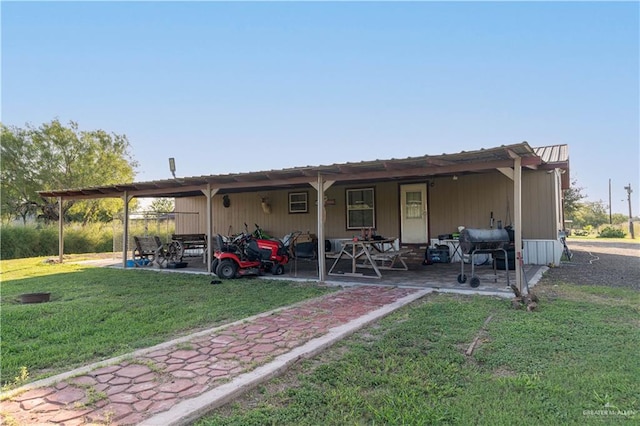 rear view of house featuring a lawn