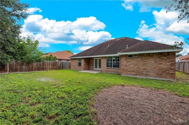 rear view of house with a lawn