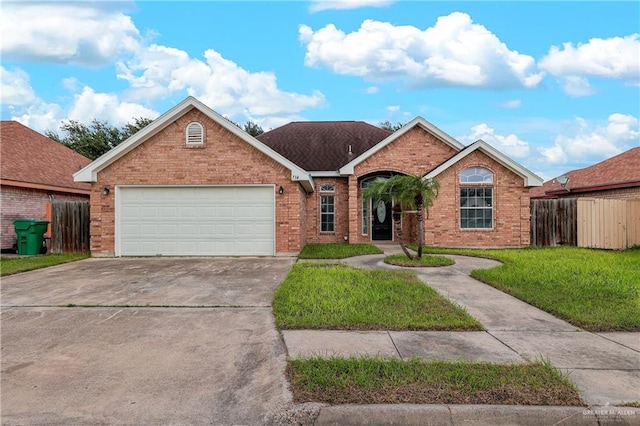 view of front of home featuring a front lawn and a garage