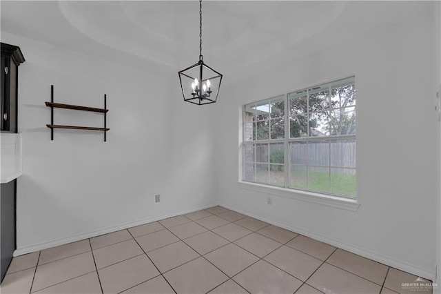 unfurnished dining area featuring light tile patterned floors and a chandelier