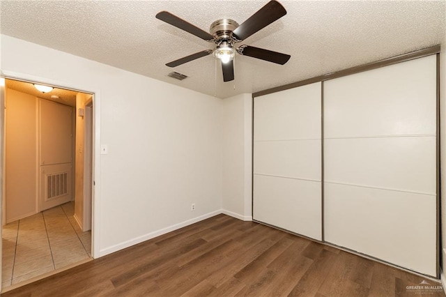 5111 Other, San Antonio, TX 78217 - unfurnished bedroom with wood finished floors, a textured ceiling, ceiling fan, a closet, and baseboards