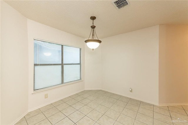 5111 Other, San Antonio, TX 78217 - unfurnished room featuring light tile patterned floors, a textured ceiling, and baseboards