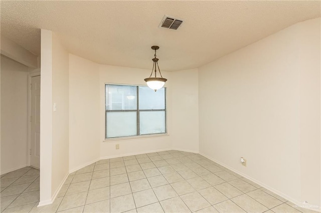 5111 Other, San Antonio, TX 78217 - empty room featuring light tile patterned floors, a textured ceiling, and baseboards