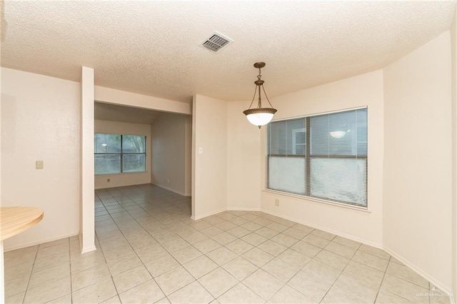 5111 Other, San Antonio, TX 78217 - unfurnished room with light tile patterned floors, a textured ceiling, and baseboards