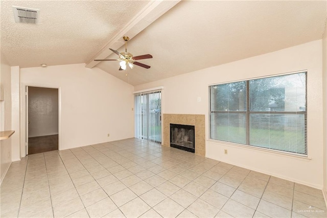 5111 Other, San Antonio, TX 78217 - unfurnished living room featuring ceiling fan, a tiled fireplace, light tile patterned floors, and a textured ceiling