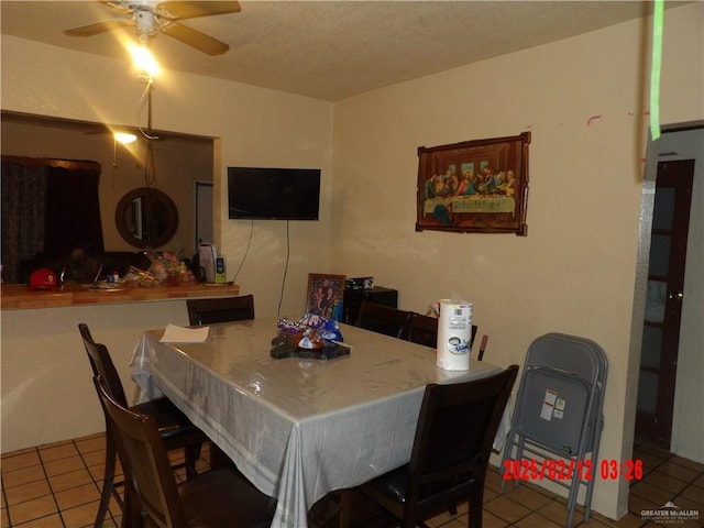 tiled dining room featuring ceiling fan