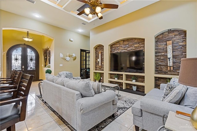 tiled living room featuring french doors, ceiling fan, and coffered ceiling