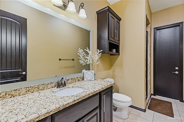 bathroom with tile patterned flooring, vanity, and toilet