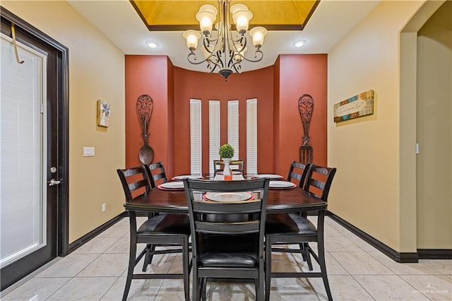 tiled dining room with a notable chandelier