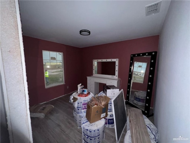 bedroom with dark hardwood / wood-style flooring