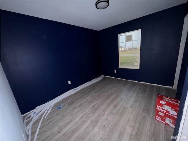 spare room with hardwood / wood-style flooring