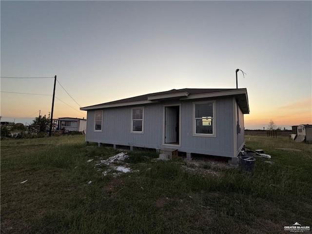 view of back house at dusk