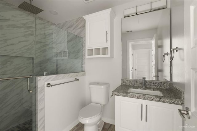 bathroom with an enclosed shower, vanity, hardwood / wood-style floors, and toilet