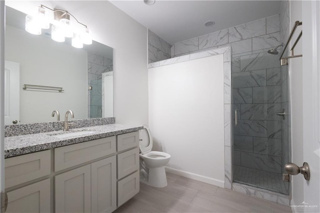 bathroom with vanity, toilet, and a shower with shower door