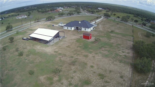 birds eye view of property with a rural view