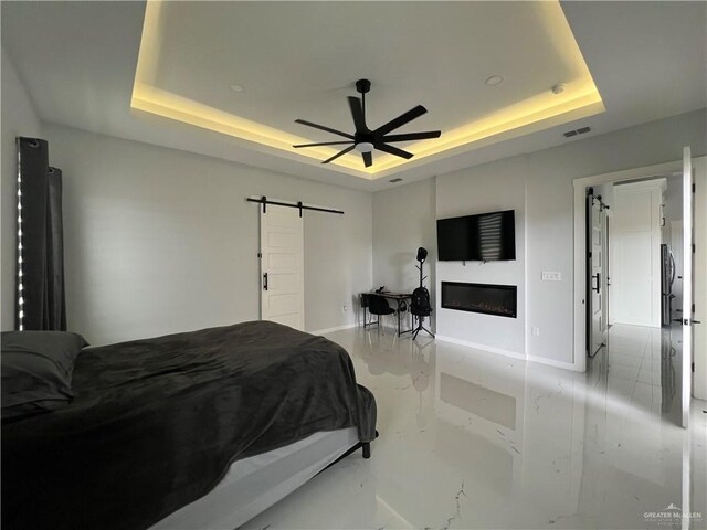 bedroom featuring a tray ceiling and ceiling fan