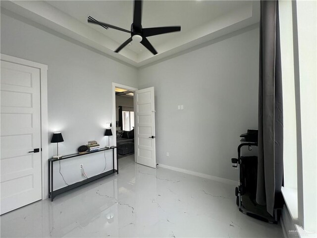 bedroom with a raised ceiling and a chandelier