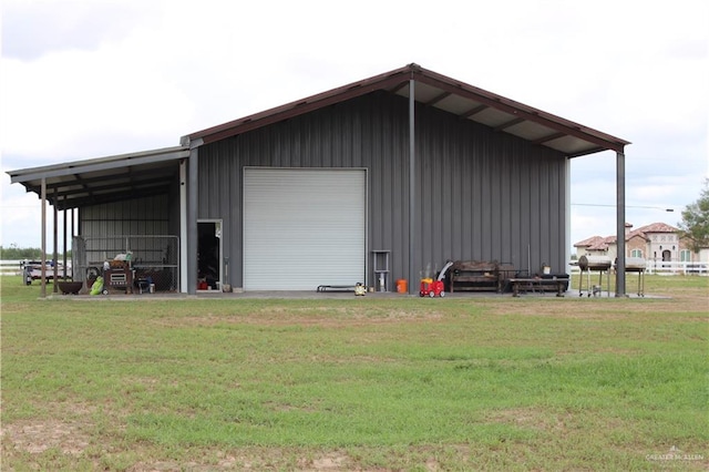 view of outbuilding with a yard and a garage