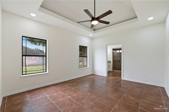 406 Casiano St, Donna, TX 78537 - spare room with a ceiling fan, recessed lighting, a raised ceiling, baseboards, and tile patterned flooring