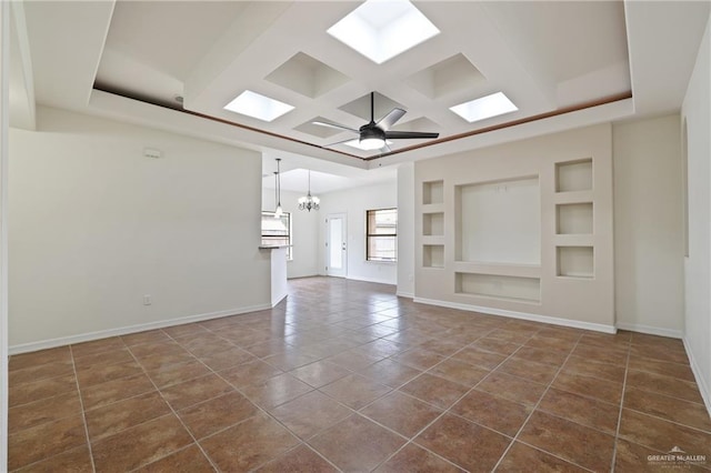 406 Casiano St, Donna, TX 78537 - unfurnished living room with coffered ceiling, a chandelier, built in features, baseboards, and dark tile patterned floors