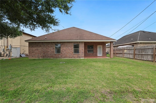 406 Casiano St, Donna, TX 78537 - rear view of property with brick siding, a patio area, and roof with shingles