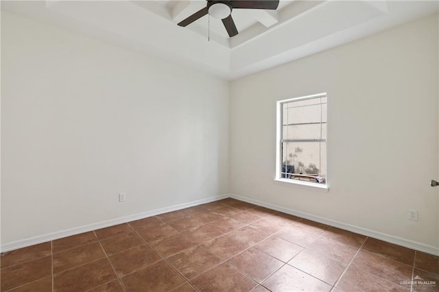 406 Casiano St, Donna, TX 78537 - tiled spare room featuring a ceiling fan, a raised ceiling, and baseboards