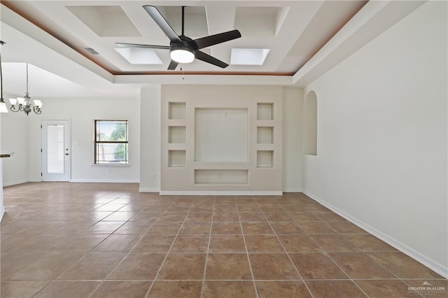 406 Casiano St, Donna, TX 78537 - unfurnished living room featuring tile patterned floors, a chandelier, a ceiling fan, baseboards, and built in shelves