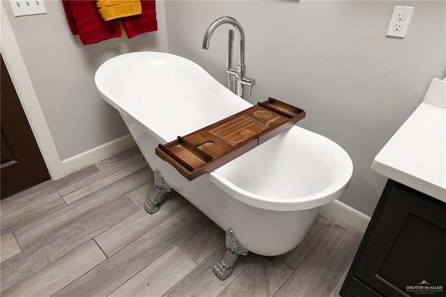 1801 Ozark Ave, Mcallen, TX 78504 - full bath featuring a freestanding bath, baseboards, vanity, and wood finished floors