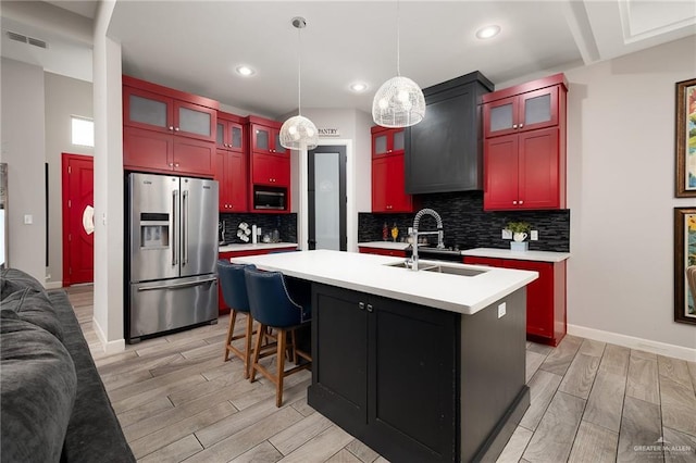 1801 Ozark Ave, Mcallen, TX 78504 - kitchen with stainless steel appliances, wood finish floors, light countertops, reddish brown cabinets, and recessed lighting