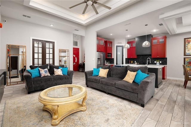1801 Ozark Ave, Mcallen, TX 78504 - living room with a ceiling fan, recessed lighting, a raised ceiling, french doors, and light wood-style floors