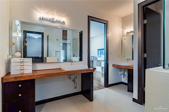 bathroom with sink, tile patterned floors, and walk in shower