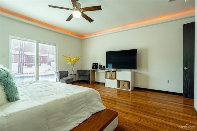 bedroom with hardwood / wood-style flooring, ceiling fan, and access to exterior