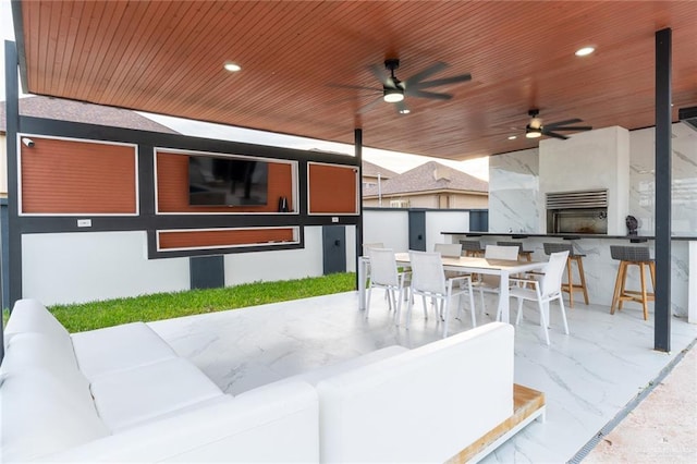 view of patio with ceiling fan and exterior bar