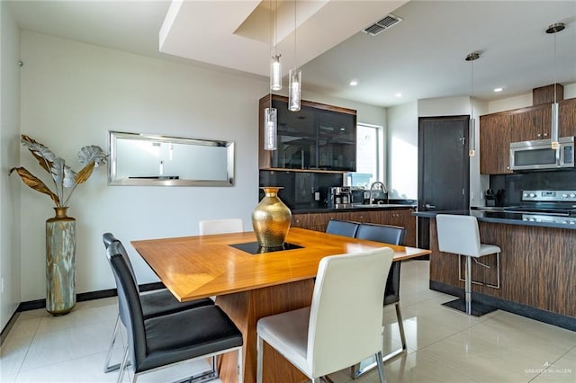 tiled dining room with sink