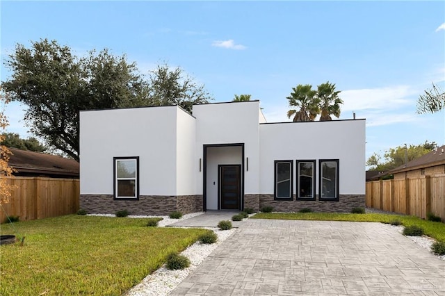 modern home with a front lawn