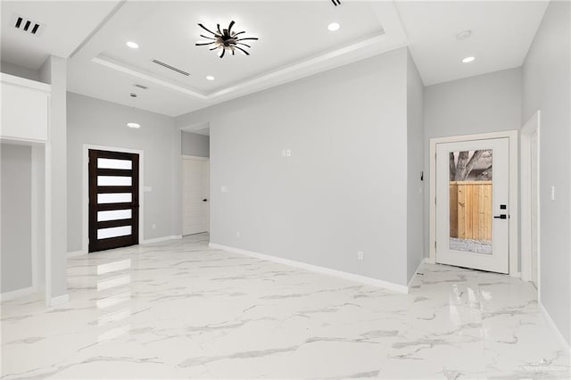 foyer entrance featuring a raised ceiling and french doors