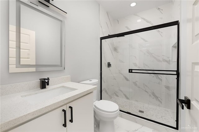 bathroom with vanity, toilet, and walk in shower