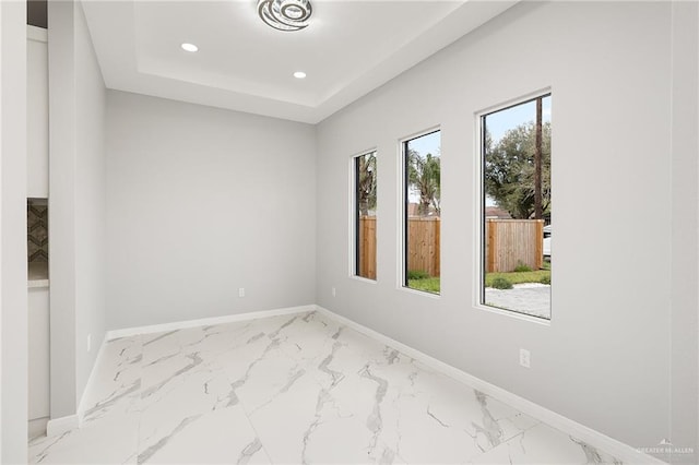 empty room featuring a raised ceiling