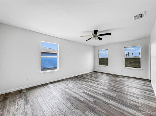 empty room featuring wood-type flooring and ceiling fan