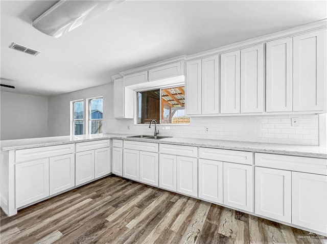 kitchen with a healthy amount of sunlight, white cabinetry, and sink