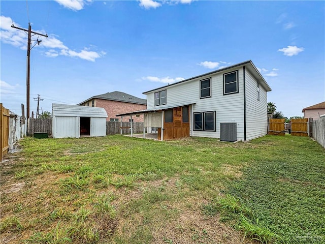 rear view of property featuring an outdoor structure, cooling unit, and a yard