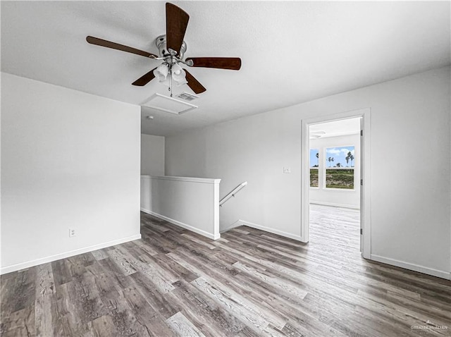 spare room with dark hardwood / wood-style floors and ceiling fan