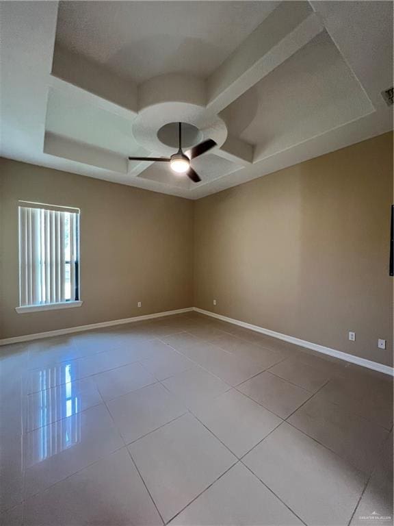 spare room with light tile patterned floors, coffered ceiling, a ceiling fan, and baseboards