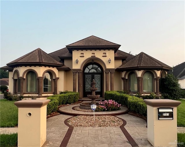 mediterranean / spanish house featuring stucco siding